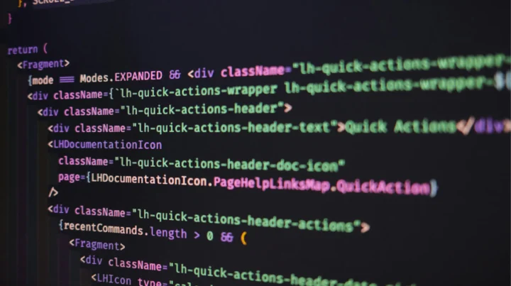Close-up of front-end web development code on a dark screen showing HTML and JavaScript